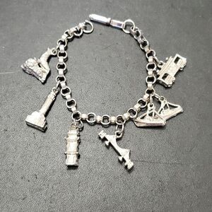 Silver tone travel themed charm bracelet 7"